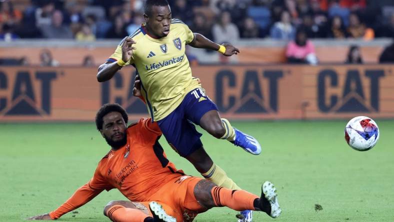 Nov 11, 2023; Houston, Texas, USA; Real Salt Lake forward Carlos Andres Gomez (11) and Houston Dynamo defender Micael (31) battle for the ball during the second half at Shell Energy Stadium. Mandatory Credit: Troy Taormina-USA TODAY Sports