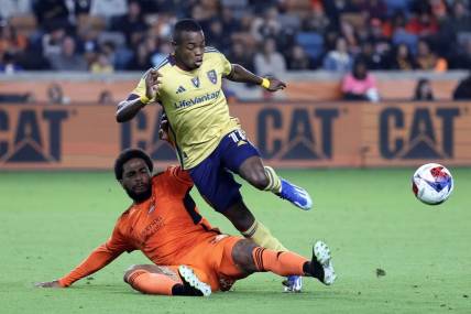 Nov 11, 2023; Houston, Texas, USA; Real Salt Lake forward Carlos Andres Gomez (11) and Houston Dynamo defender Micael (31) battle for the ball during the second half at Shell Energy Stadium. Mandatory Credit: Troy Taormina-USA TODAY Sports