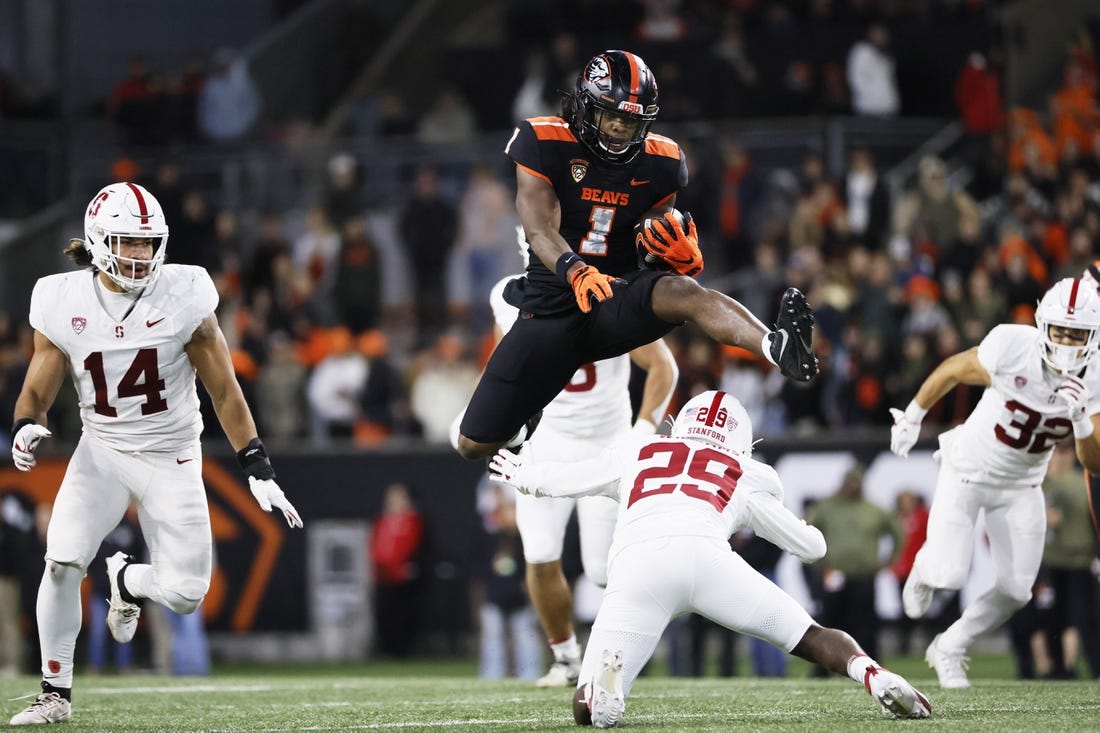 Nov 11, 2023; Corvallis, Oregon, USA; Oregon State Beavers running back Deshaun Fenwick (1) jumps over Stanford Cardinal corner back Terian Williams (29) during the second half at Reser Stadium. Mandatory Credit: Soobum Im-USA TODAY Sports