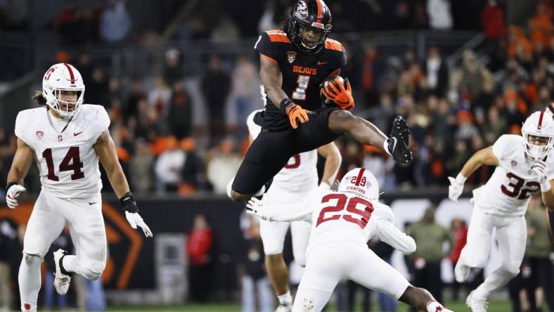 Nov 11, 2023; Corvallis, Oregon, USA; Oregon State Beavers running back Deshaun Fenwick (1) jumps over Stanford Cardinal corner back Terian Williams (29) during the second half at Reser Stadium. Mandatory Credit: Soobum Im-USA TODAY Sports