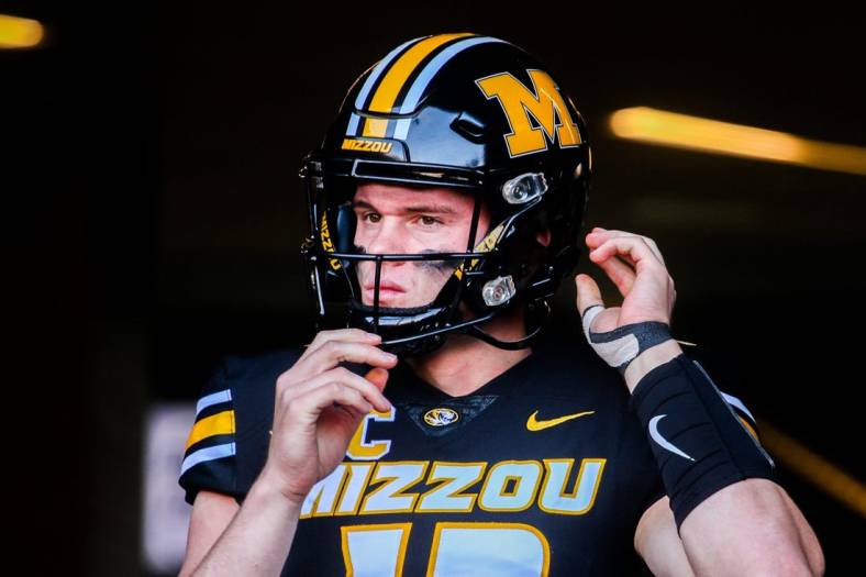 Missouri quarterback Brady Cook adjusts his helmet before a college football game at Faurot Field on Nov. 11, 2023, in Columbia, Mo.