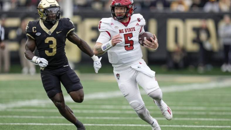 Nov 11, 2023; Winston-Salem, North Carolina, USA; Wake Forest Demon Deacons defensive back Malik Mustapha (3) chases North Carolina State Wolfpack quarterback Brennan Armstrong (5) during the first half at Allegacy Federal Credit Union Stadium. Mandatory Credit: Jim Dedmon-USA TODAY Sports