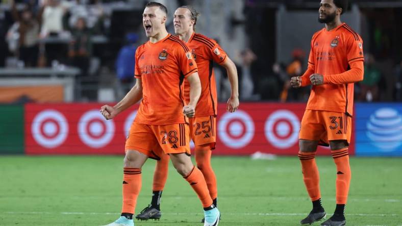 Nov 11, 2023; Houston, Texas, USA; Houston Dynamo defender Erik Sviatchenko (28), midfielder Griffin Dorsey (25), and defender Micael (31) react after the game against Real Salt Lake at Shell Energy Stadium. Mandatory Credit: Troy Taormina-USA TODAY Sports