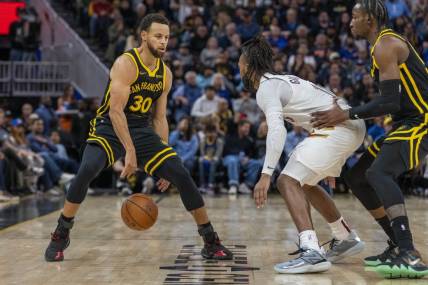 Nov 11, 2023; San Francisco, California, USA;  Golden State Warriors guard Stephen Curry (30) dribbles the basketball against Cleveland Cavaliers guard Darius Garland (10) during the fourth quarter at Chase Center. Mandatory Credit: Neville E. Guard-USA TODAY Sports