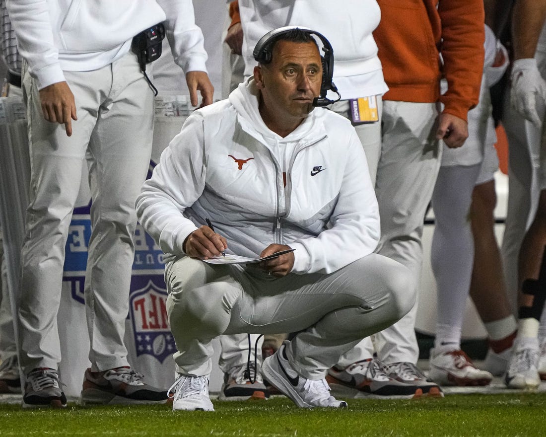 Nov 11, 2023; Fort Worth, Texas, USA; Texas Longhorns head coach Steve Sarkisian kneels on the sideline during the game against the TCU Horned Frogs at Amon G. Carter Stadium. Mandatory Credit: Aaron E. Martinez-USA TODAY Sports