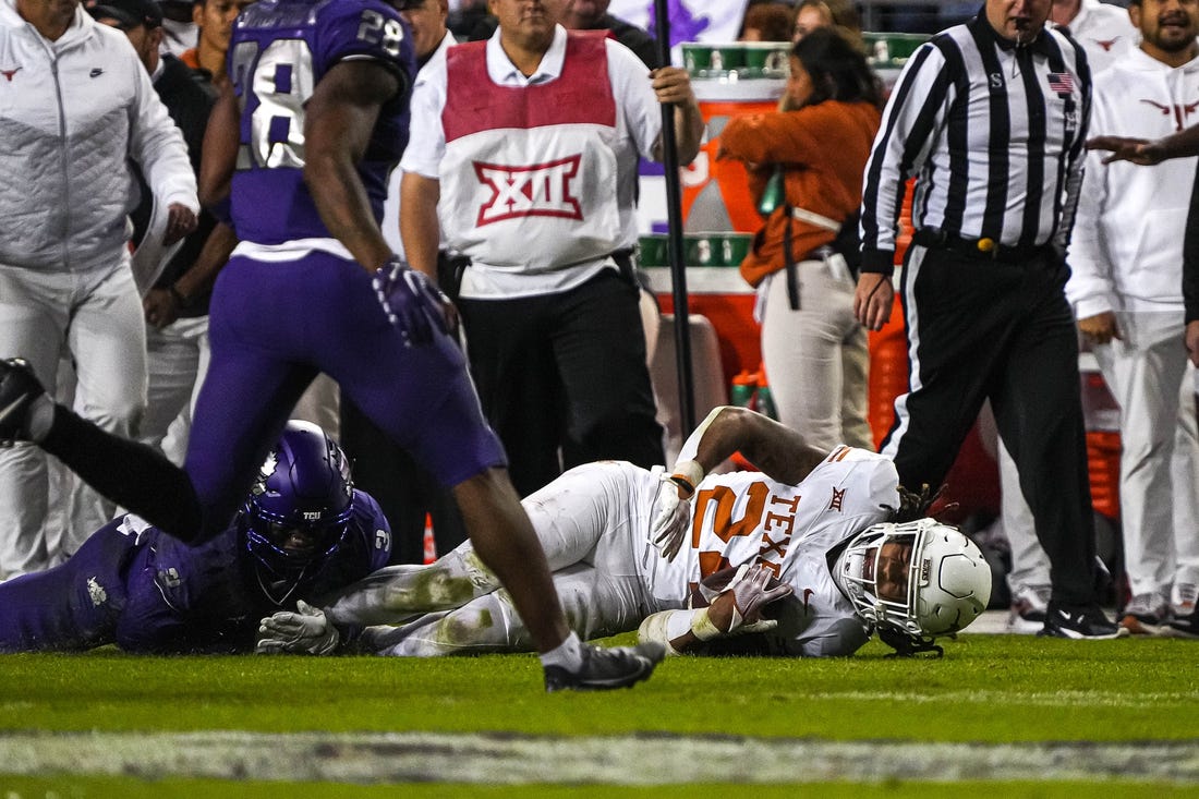 Nov 11, 2023; Fort Worth, Texas, USA; Texas Longhorns running back Jonathon Brooks (24) is brought down by TCU Horned Frogs cornerback Josh Newton (3) during the game at Amon G. Carter Stadium. Mandatory Credit: Aaron E. Martinez-USA TODAY Sports