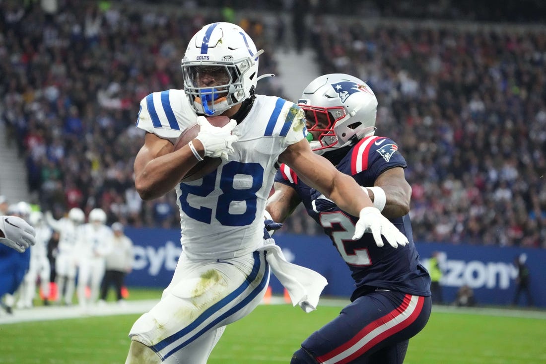 Nov 12, 2023; Frankfurt, Germany; Indianapolis Colts running back Jonathan Taylor (28) scores on a 1-yard touchdown run against New England Patriots cornerback Jalen Mills (2) in the first half during an NFL International Series game at Deutsche Bank Park. Mandatory Credit: Kirby Lee-USA TODAY Sports