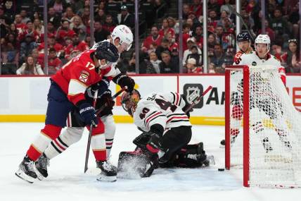 Nov 12, 2023; Sunrise, Florida, USA; Chicago Blackhawks goaltender Arvid Soderblom (40) allows a goal to Florida Panthers center Sam Reinhart (13) during the second period at Amerant Bank Arena. Mandatory Credit: Jasen Vinlove-USA TODAY Sports