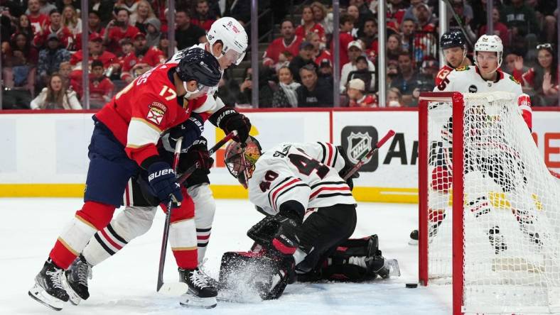 Nov 12, 2023; Sunrise, Florida, USA; Chicago Blackhawks goaltender Arvid Soderblom (40) allows a goal to Florida Panthers center Sam Reinhart (13) during the second period at Amerant Bank Arena. Mandatory Credit: Jasen Vinlove-USA TODAY Sports