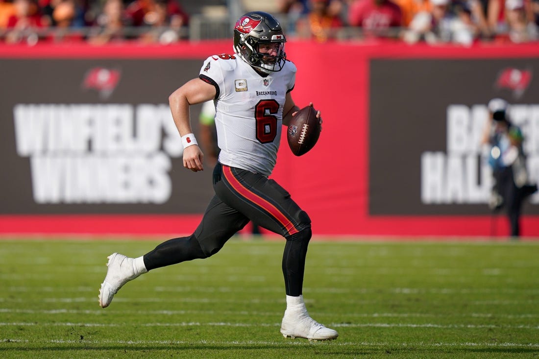 Tampa Bay Buccaneers quarterback Baker Mayfield (6) runs the ball for a first down against the Tennessee Titans during the fourth quarter at Raymond James Stadium in Tampa, Fla., Sunday, Nov. 12, 2023.