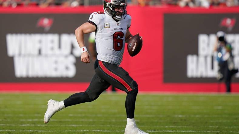 Tampa Bay Buccaneers quarterback Baker Mayfield (6) runs the ball for a first down against the Tennessee Titans during the fourth quarter at Raymond James Stadium in Tampa, Fla., Sunday, Nov. 12, 2023.