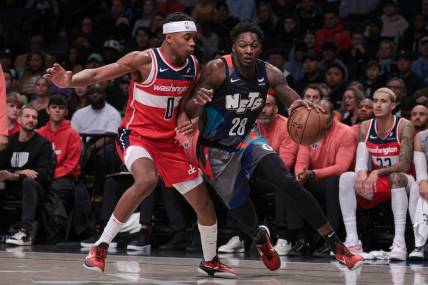 Nov 12, 2023; Brooklyn, New York, USA; Brooklyn Nets forward Dorian Finney-Smith (28) dribbles against Washington Wizards guard Bilal Coulibaly (0) during the half quarter at Barclays Center. Mandatory Credit: Vincent Carchietta-USA TODAY Sports