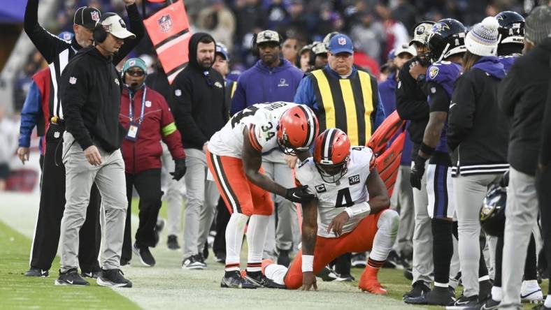 Nov 12, 2023; Baltimore, Maryland, USA;  Cleveland Browns quarterback Deshaun Watson (4) is helped up by  running back Jerome Ford (34) after being tackled out of bounds during the second half against the Baltimore Ravens at M&T Bank Stadium. Mandatory Credit: Tommy Gilligan-USA TODAY Sports