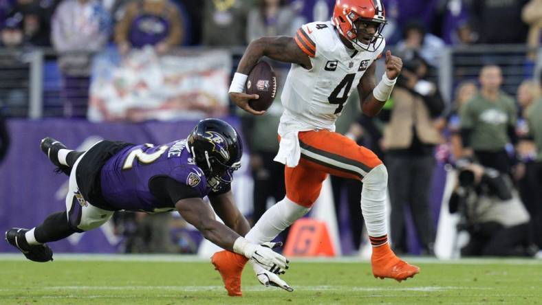 Nov 12, 2023; Baltimore, Maryland, USA; Cleveland Browns quarterback Deshaun Watson (4) runs with the ball as Baltimore Ravens defensive tackle Justin Madubuike (92) defends during the second half at M&T Bank Stadium. Mandatory Credit: Jessica Rapfogel-USA TODAY Sports