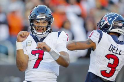 Nov 12, 2023; Cincinnati, Ohio, USA; Houston Texans quarterback C.J. Stroud (7) reacts after scoring a touchdown with wide receiver Tank Dell (3) in the second half against the Cincinnati Bengals at Paycor Stadium. Mandatory Credit: Katie Stratman-USA TODAY Sports
