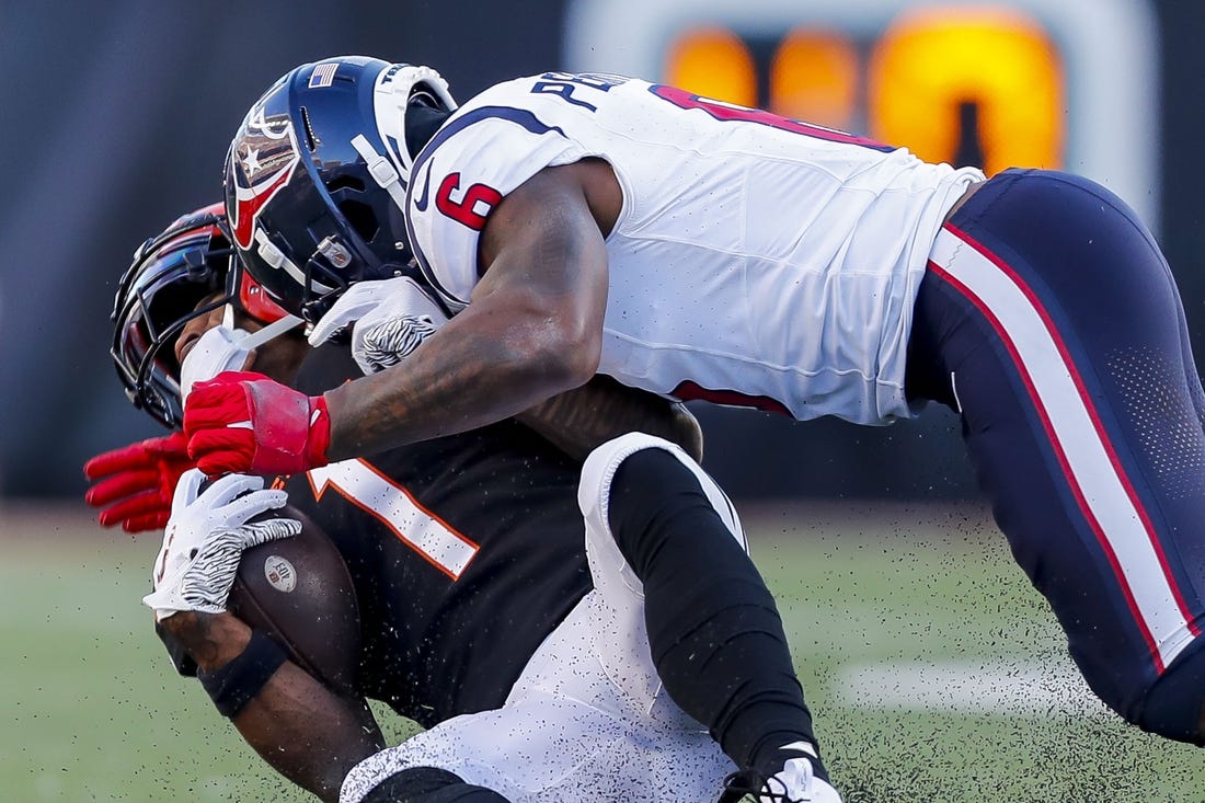 Nov 12, 2023; Cincinnati, Ohio, USA; Cincinnati Bengals wide receiver Ja'Marr Chase (1) collides with Houston Texans linebacker Denzel Perryman (6) in the second half at Paycor Stadium. Mandatory Credit: Katie Stratman-USA TODAY Sports