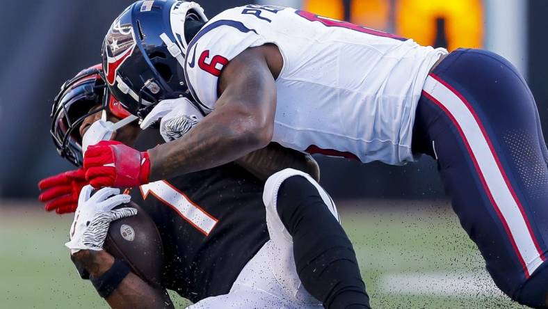 Nov 12, 2023; Cincinnati, Ohio, USA; Cincinnati Bengals wide receiver Ja'Marr Chase (1) collides with Houston Texans linebacker Denzel Perryman (6) in the second half at Paycor Stadium. Mandatory Credit: Katie Stratman-USA TODAY Sports