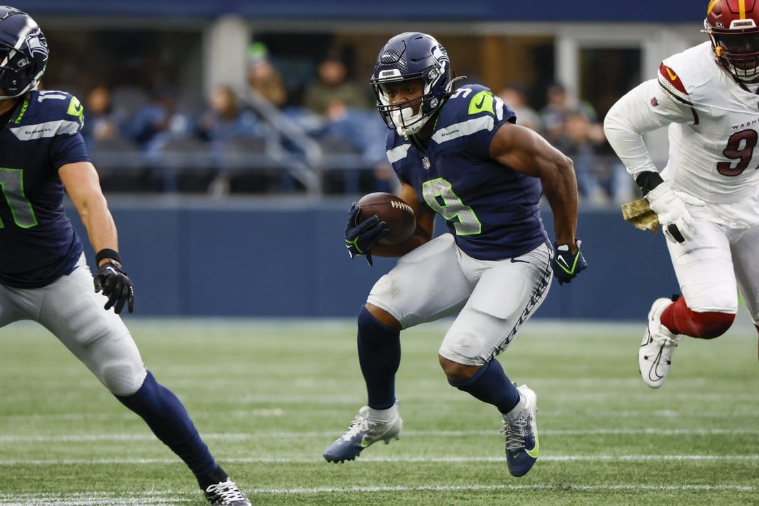 Nov 12, 2023; Seattle, Washington, USA; Seattle Seahawks running back Kenneth Walker III (9) rushes against the Washington Commanders during the second quarter at Lumen Field. Mandatory Credit: Joe Nicholson-USA TODAY Sports