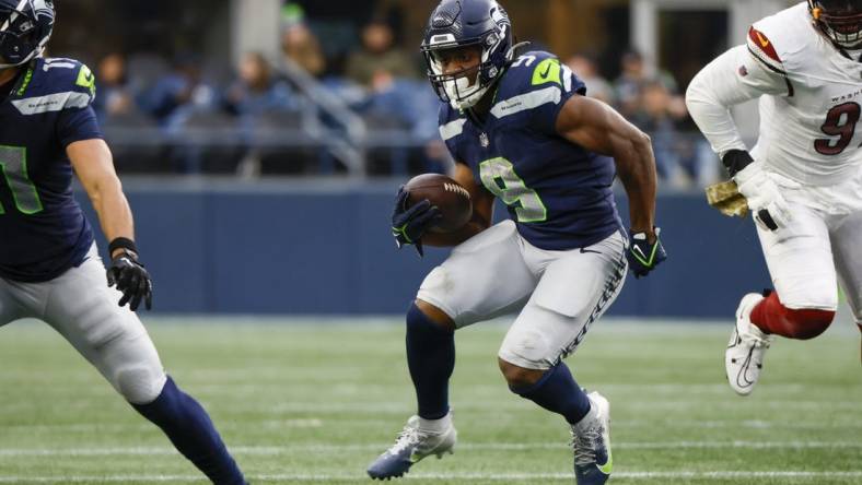 Nov 12, 2023; Seattle, Washington, USA; Seattle Seahawks running back Kenneth Walker III (9) rushes against the Washington Commanders during the second quarter at Lumen Field. Mandatory Credit: Joe Nicholson-USA TODAY Sports