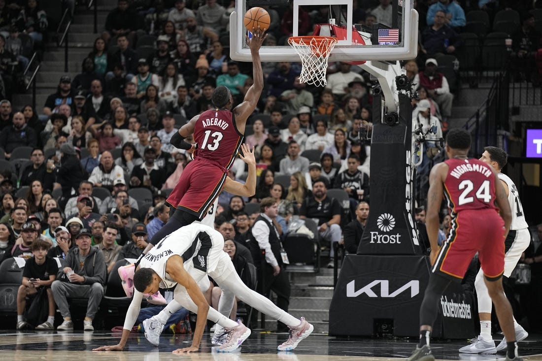 Nov 12, 2023; San Antonio, Texas, USA; Miami Heat center Bam Adebayo (13) drives to the basket past San Antonio Spurs forward Victor Wembanyama (1) during the first half at Frost Bank Center. Mandatory Credit: Scott Wachter-USA TODAY Sports