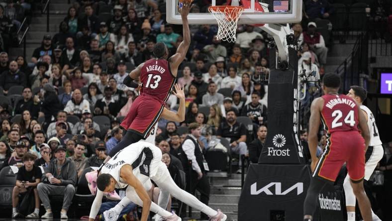 Nov 12, 2023; San Antonio, Texas, USA; Miami Heat center Bam Adebayo (13) drives to the basket past San Antonio Spurs forward Victor Wembanyama (1) during the first half at Frost Bank Center. Mandatory Credit: Scott Wachter-USA TODAY Sports