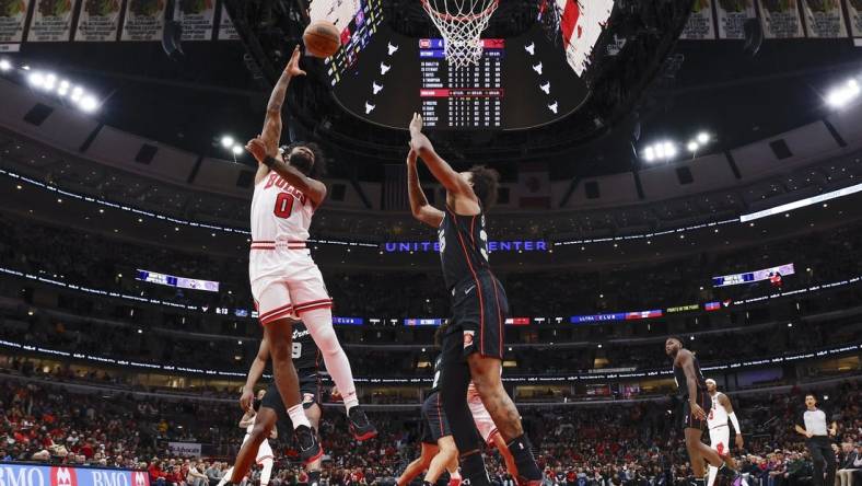 Nov 12, 2023; Chicago, Illinois, USA; Chicago Bulls guard Coby White (0) goes to the basket against Detroit Pistons forward Marvin Bagley III (35) during the first half at United Center. Mandatory Credit: Kamil Krzaczynski-USA TODAY Sports