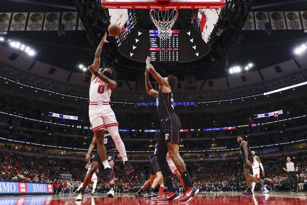 Nov 12, 2023; Chicago, Illinois, USA; Chicago Bulls guard Coby White (0) goes to the basket against Detroit Pistons forward Marvin Bagley III (35) during the first half at United Center. Mandatory Credit: Kamil Krzaczynski-USA TODAY Sports