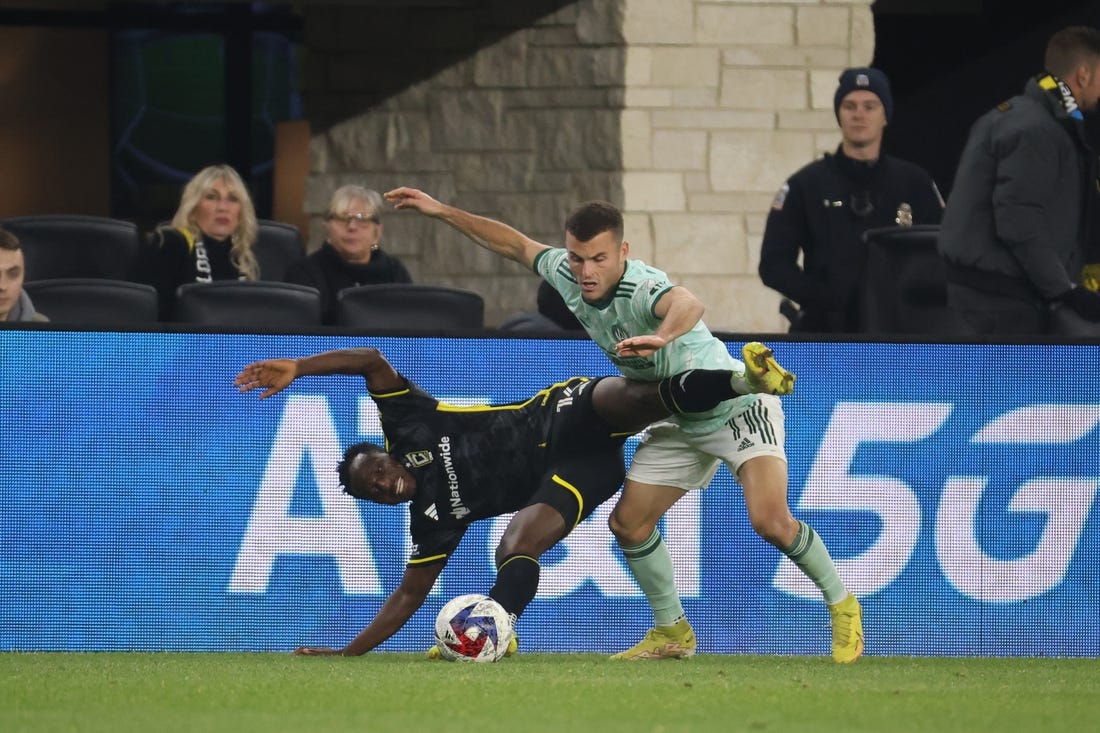 Nov 12, 2023; Columbus, Ohio, USA;  Columbus Crew midfielder Yaw Yeboah (14) is challenged by Atlanta United FC defender Brooks Lennon (11) during the second half at Lower.com Field. Mandatory Credit: Trevor Ruszkowski-USA TODAY Sports