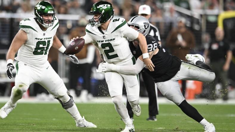 Nov 12, 2023; Paradise, Nevada, USA; New York Jets quarterback Zach Wilson (2) is tackled by Las Vegas Raiders defensive end Maxx Crosby (98) in the first quarter at Allegiant Stadium. Mandatory Credit: Candice Ward-USA TODAY Sports