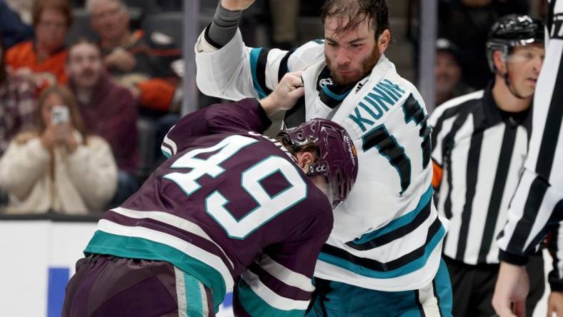 Nov 12, 2023; Anaheim, California, USA; San Jose Sharks center Luke Kunin (11) and Anaheim Ducks left wing Max Jones (49) fight during the second period at Honda Center. Mandatory Credit: Jason Parkhurst-USA TODAY Sports