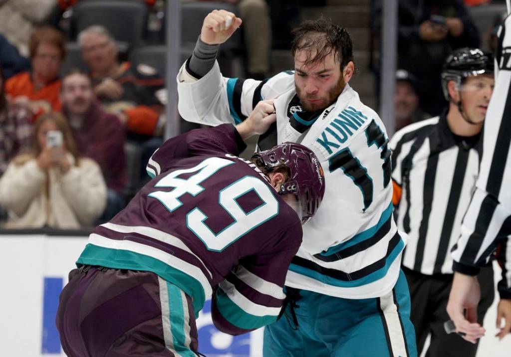 Nov 12, 2023; Anaheim, California, USA; San Jose Sharks center Luke Kunin (11) and Anaheim Ducks left wing Max Jones (49) fight during the second period at Honda Center. Mandatory Credit: Jason Parkhurst-USA TODAY Sports