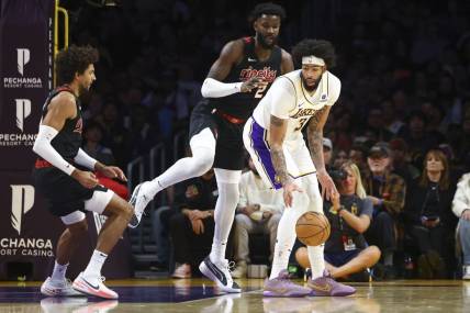 Nov 12, 2023; Los Angeles, California, USA; Los Angeles Lakers forward Anthony Davis (3) dribbles against Portland Trail Blazers center Deandre Ayton (2) during the first half of a game at Crypto.com Arena. Mandatory Credit: Jessica Alcheh-USA TODAY Sports