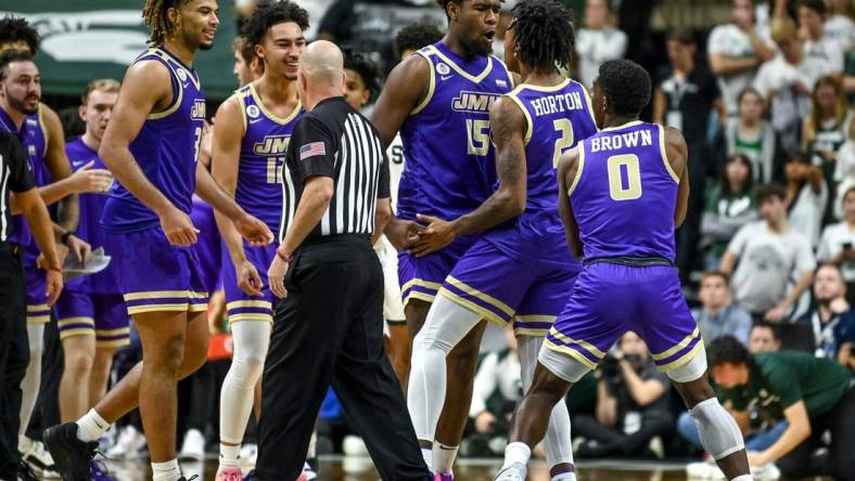 James Madison celebrates after Raekwon Horton (2) made a 3-pointer against Michigan State during overtime on Monday, Nov. 6, 2023, in East Lansing.