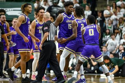 James Madison celebrates after Raekwon Horton (2) made a 3-pointer against Michigan State during overtime on Monday, Nov. 6, 2023, in East Lansing.