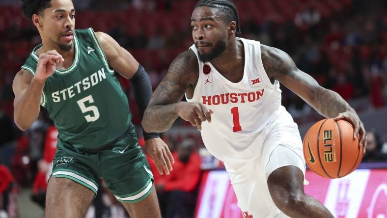 Nov 13, 2023; Houston, Texas, USA; Houston Cougars guard Jamal Shead (1) controls the ball as Stetson Hatters guard Jalen Blackmon (5) defends during the first half at Fertitta Center. Mandatory Credit: Troy Taormina-USA TODAY Sports