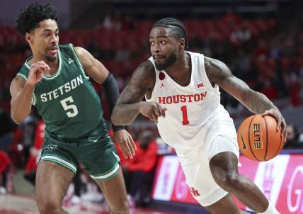 Nov 13, 2023; Houston, Texas, USA; Houston Cougars guard Jamal Shead (1) controls the ball as Stetson Hatters guard Jalen Blackmon (5) defends during the first half at Fertitta Center. Mandatory Credit: Troy Taormina-USA TODAY Sports