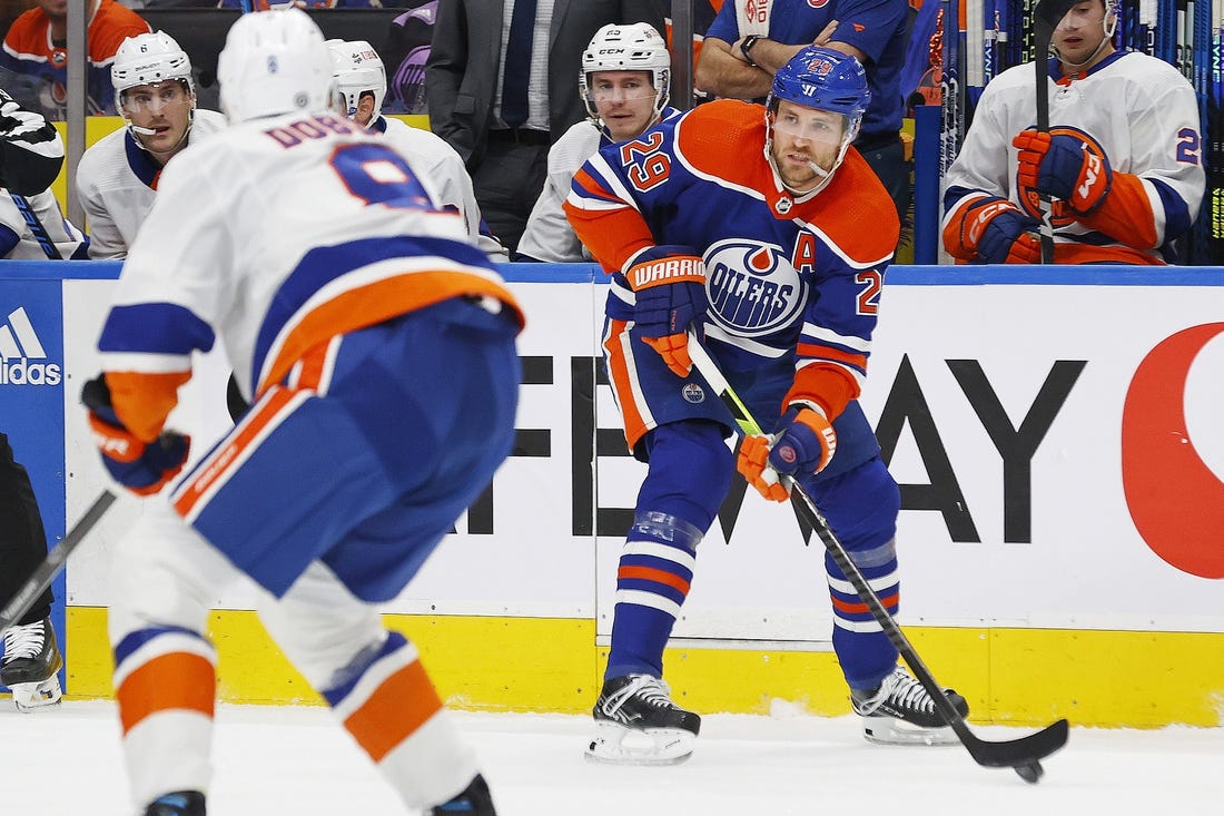 Nov 13, 2023; Edmonton, Alberta, CAN; Edmonton Oilers forward Leon Draisaitl (29) looks to make a pass in front of New York Islanders defensemen Noah Dobson (8) during the first period at Rogers Place. Mandatory Credit: Perry Nelson-USA TODAY Sports