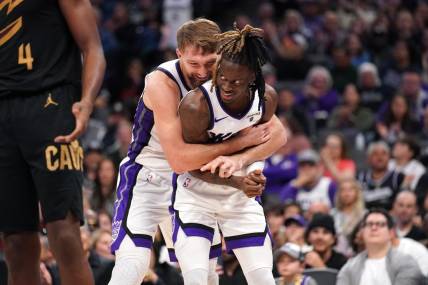 Nov 13, 2023; Sacramento, California, USA; Sacramento Kings forward Domantas Sabonis (10) hugs guard Keon Ellis (23) after Sabonis made a basket while being fouled against the Cleveland Cavaliers in the fourth quarter at the Golden 1 Center. Mandatory Credit: Cary Edmondson-USA TODAY Sports