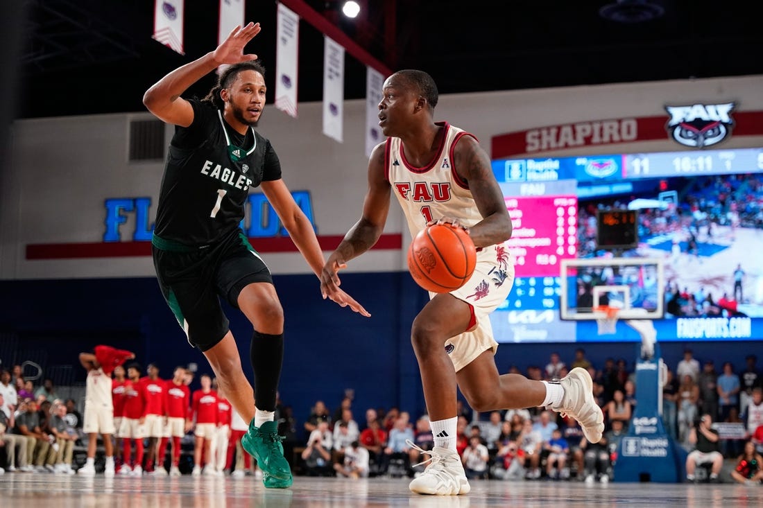 Nov 14, 2023; Boca Raton, Florida, USA; Florida Atlantic Owls guard Johnell Davis (1) dribbles the ball past Eastern Michigan Eagles forward Jalin Billingsley (1) during the first half at Eleanor R. Baldwin Arena. Mandatory Credit: Rich Storry-USA TODAY Sports