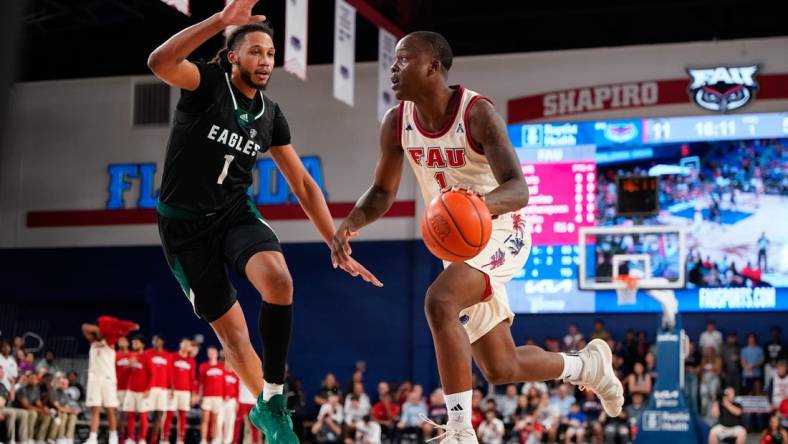 Nov 14, 2023; Boca Raton, Florida, USA; Florida Atlantic Owls guard Johnell Davis (1) dribbles the ball past Eastern Michigan Eagles forward Jalin Billingsley (1) during the first half at Eleanor R. Baldwin Arena. Mandatory Credit: Rich Storry-USA TODAY Sports