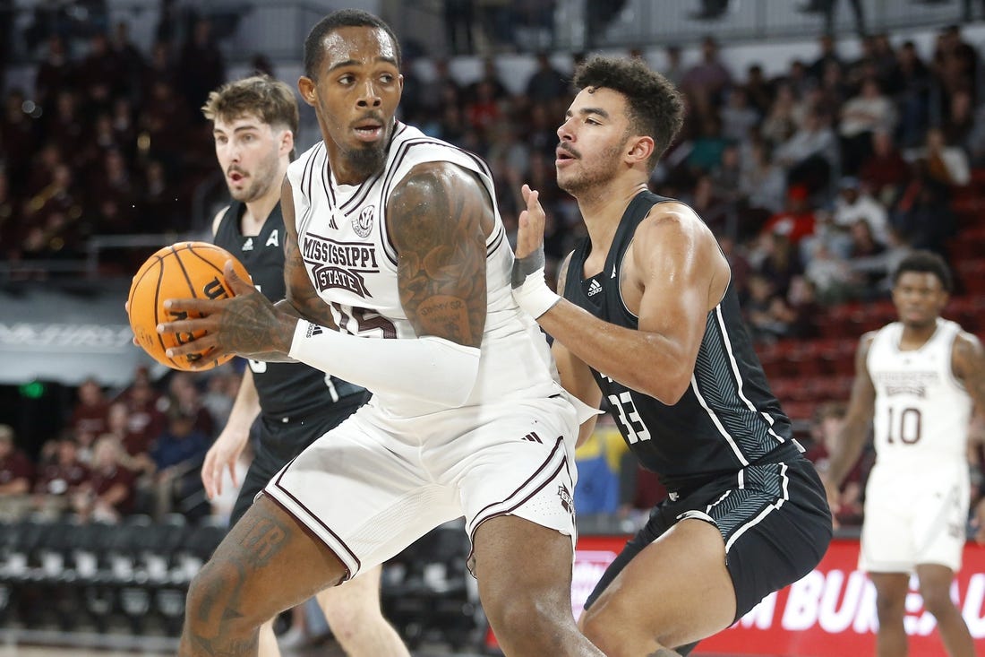 Nov 14, 2023; Starkville, Mississippi, USA; Mississippi State Bulldogs forward Jimmy Bell Jr. (15) spins toward the basket as North Alabama Lions forward Damian Forrest (33) defends during the first half at Humphrey Coliseum. Mandatory Credit: Petre Thomas-USA TODAY Sports