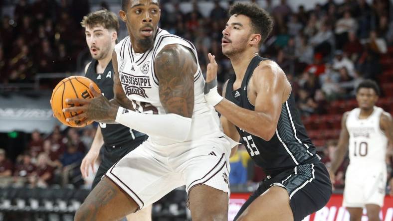 Nov 14, 2023; Starkville, Mississippi, USA; Mississippi State Bulldogs forward Jimmy Bell Jr. (15) spins toward the basket as North Alabama Lions forward Damian Forrest (33) defends during the first half at Humphrey Coliseum. Mandatory Credit: Petre Thomas-USA TODAY Sports