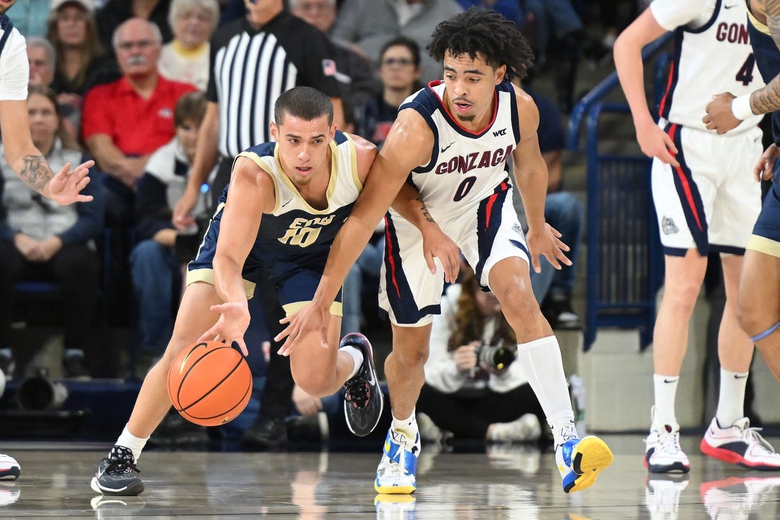 Nov 14, 2023; Spokane, Washington, USA; Gonzaga Bulldogs guard Ryan Nembhard (0) reaches in for the steal attempt against Eastern Oregon Mountaineers guard Malachi Afework (10) in the first half at McCarthey Athletic Center. Mandatory Credit: James Snook-USA TODAY Sports