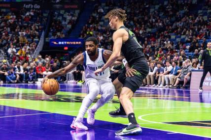 Nov 14, 2023; New Orleans, Louisiana, USA;  Dallas Mavericks guard Kyrie Irving (11) dribbles around New Orleans Pelicans guard Dyson Daniels (11) during the first half at the Smoothie King Center. Mandatory Credit: Stephen Lew-USA TODAY Sports