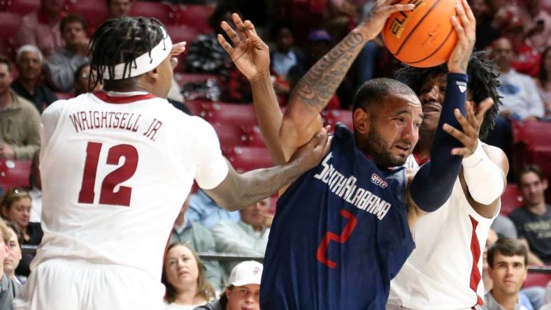 Nov 14, 2023; Tuscaloosa, Alabama, USA; South Alabama guard Isiah Gaiter (2) fights for the ball against Alabama guard Latrell Wrightsell Jr. (12) and guard Davin Cosby Jr. (4) during the second half Coleman Coliseum. Mandatory Credit: Gary Cosby Jr.-USA TODAY Sports