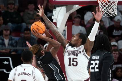 Nov 14, 2023; Starkville, Mississippi, USA; Mississippi State Bulldogs forward Jimmy Bell Jr. (15) defends as North Alabama Lions guard Micah Clark (1) shoots during the first half at Humphrey Coliseum. Mandatory Credit: Petre Thomas-USA TODAY Sports