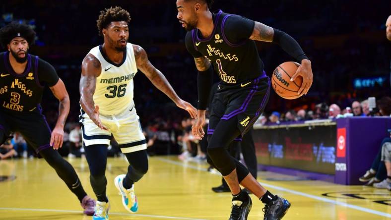 Nov 14, 2023; Los Angeles, California, USA; Los Angeles Lakers guard D   Angelo Russell (1) moves the ball against Memphis Grizzlies guard Marcus Smart (36) during the first half at Crypto.com Arena. Mandatory Credit: Gary A. Vasquez-USA TODAY Sports