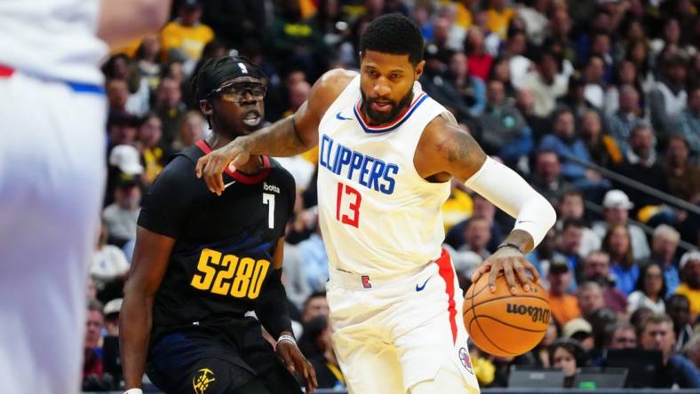 Nov 14, 2023; Denver, Colorado, USA;  LA Clippers forward Paul George (13) drives to the basket against Denver Nuggets guard Reggie Jackson (7) in the second quarter at Ball Arena. Mandatory Credit: Ron Chenoy-USA TODAY Sports