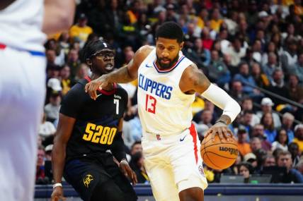 Nov 14, 2023; Denver, Colorado, USA;  LA Clippers forward Paul George (13) drives to the basket against Denver Nuggets guard Reggie Jackson (7) in the second quarter at Ball Arena. Mandatory Credit: Ron Chenoy-USA TODAY Sports