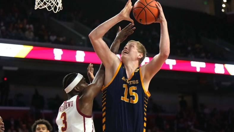 Nov 14, 2023; Los Angeles, California, USA; UC Irvine Anteaters center Bent Leuchten (15) shoots the ball against Southern California Trojans forward Vincent Iwuchukwu (3)  in the first half at Galen Center. Mandatory Credit: Kirby Lee-USA TODAY Sports